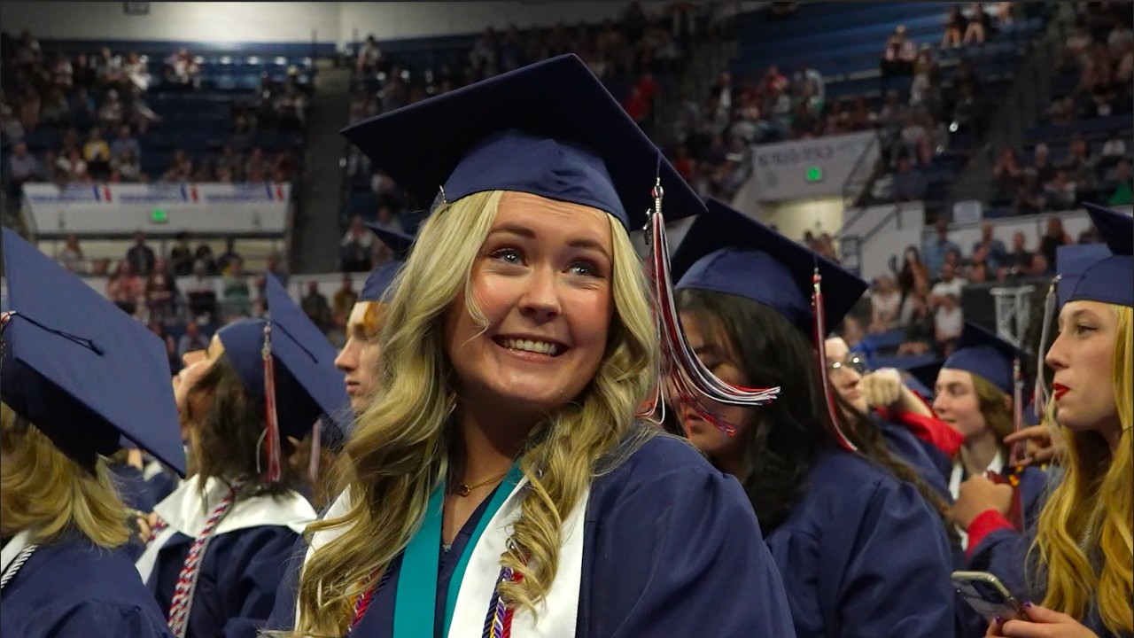 An LHS student smiles, recognizing a family member at her graduation ceremony.